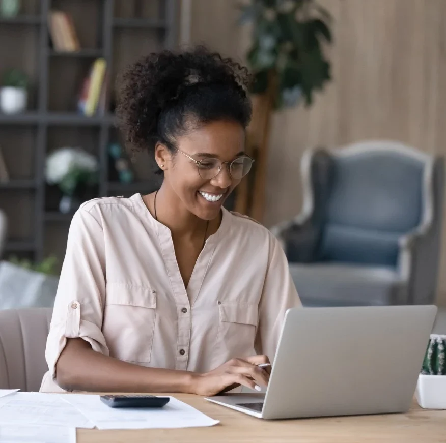 Happy woman using laptop to make an NDIS referral