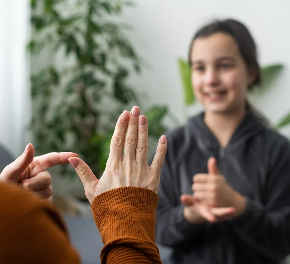 Young girl communicating via sign language